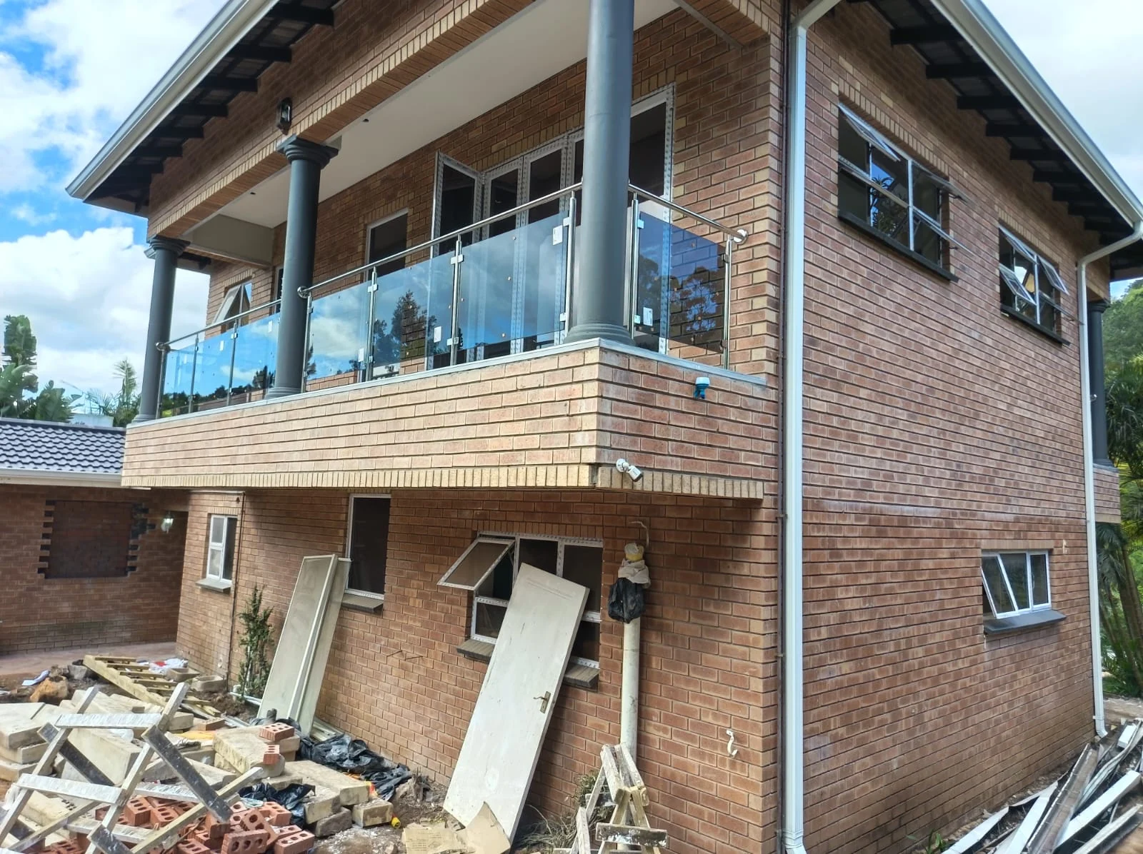 Glass balustrade on a brick residential balcony